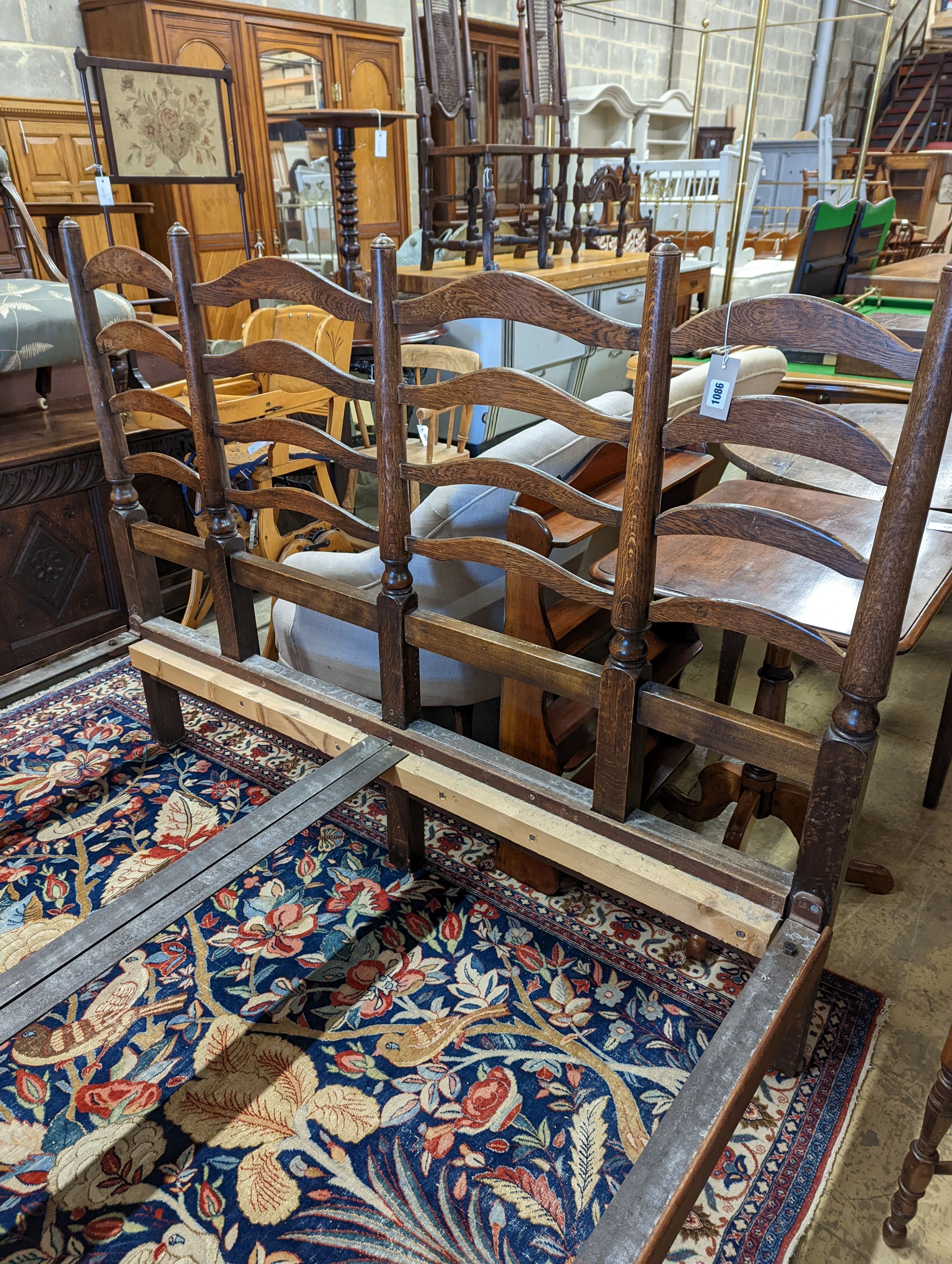 A 1920's oak ladderback double bed frame, width 157cm